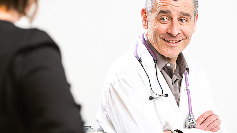 Doctor smiling with a female