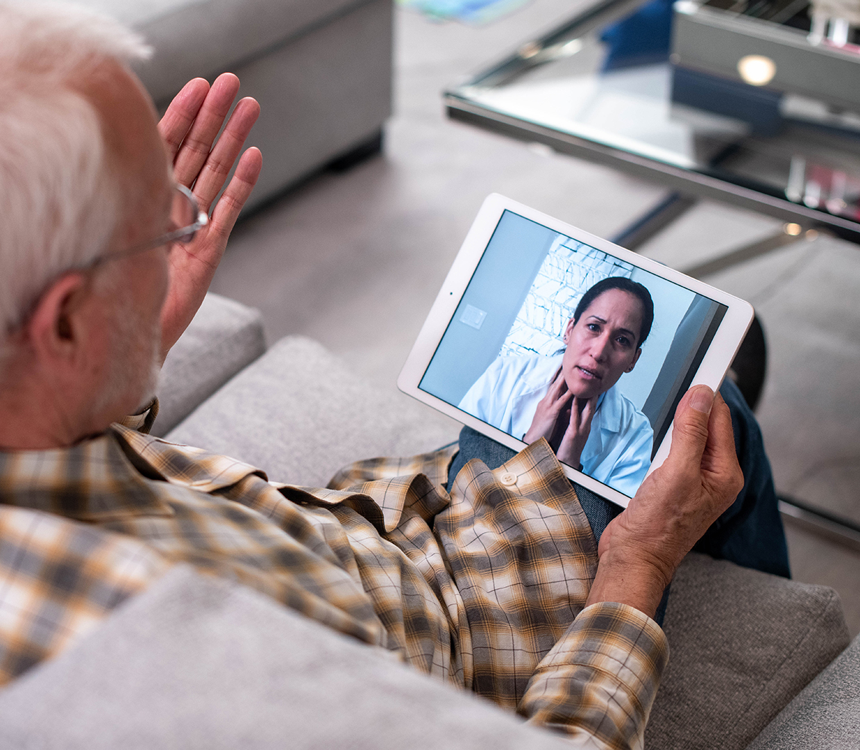 elder man talking to doctor, teleconsulting