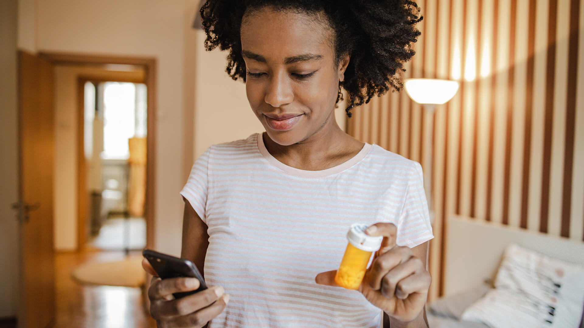 woman holding a bottle of pills