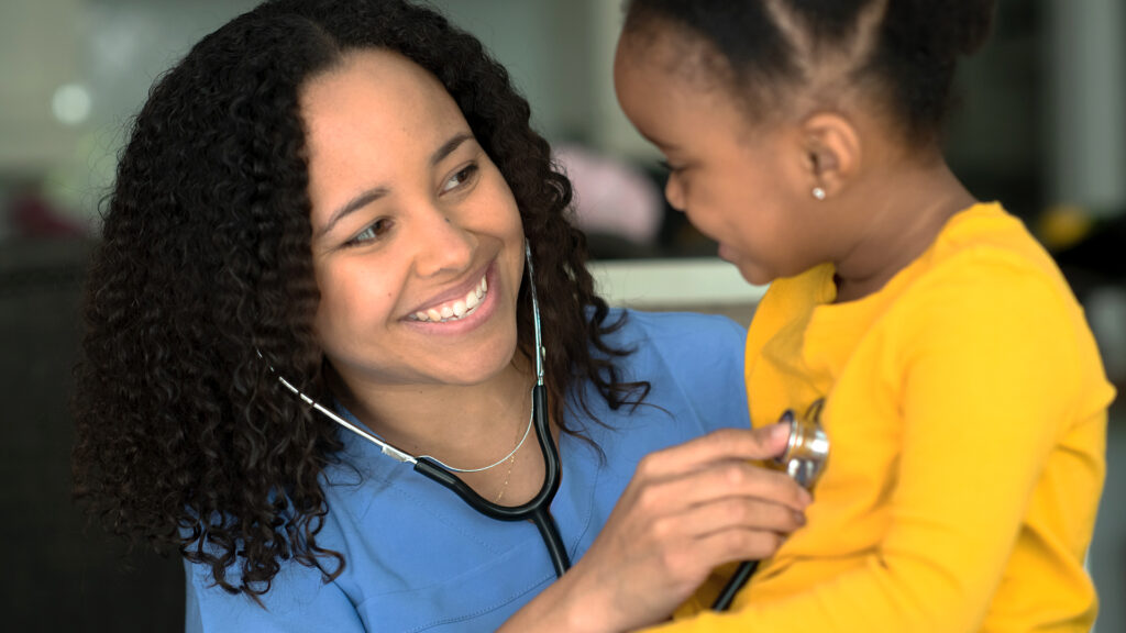 pediatrician performing a check up on a child