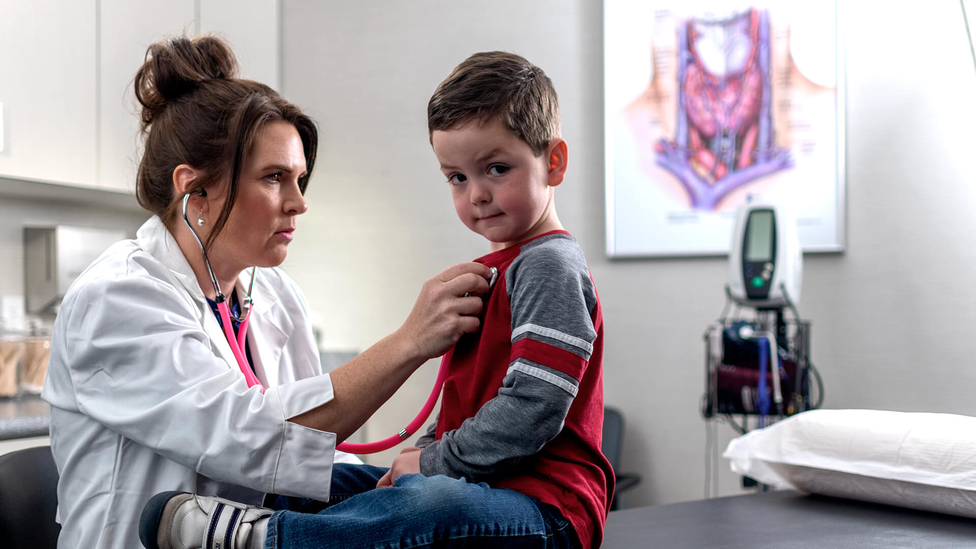 pediatrician checking up on young boy