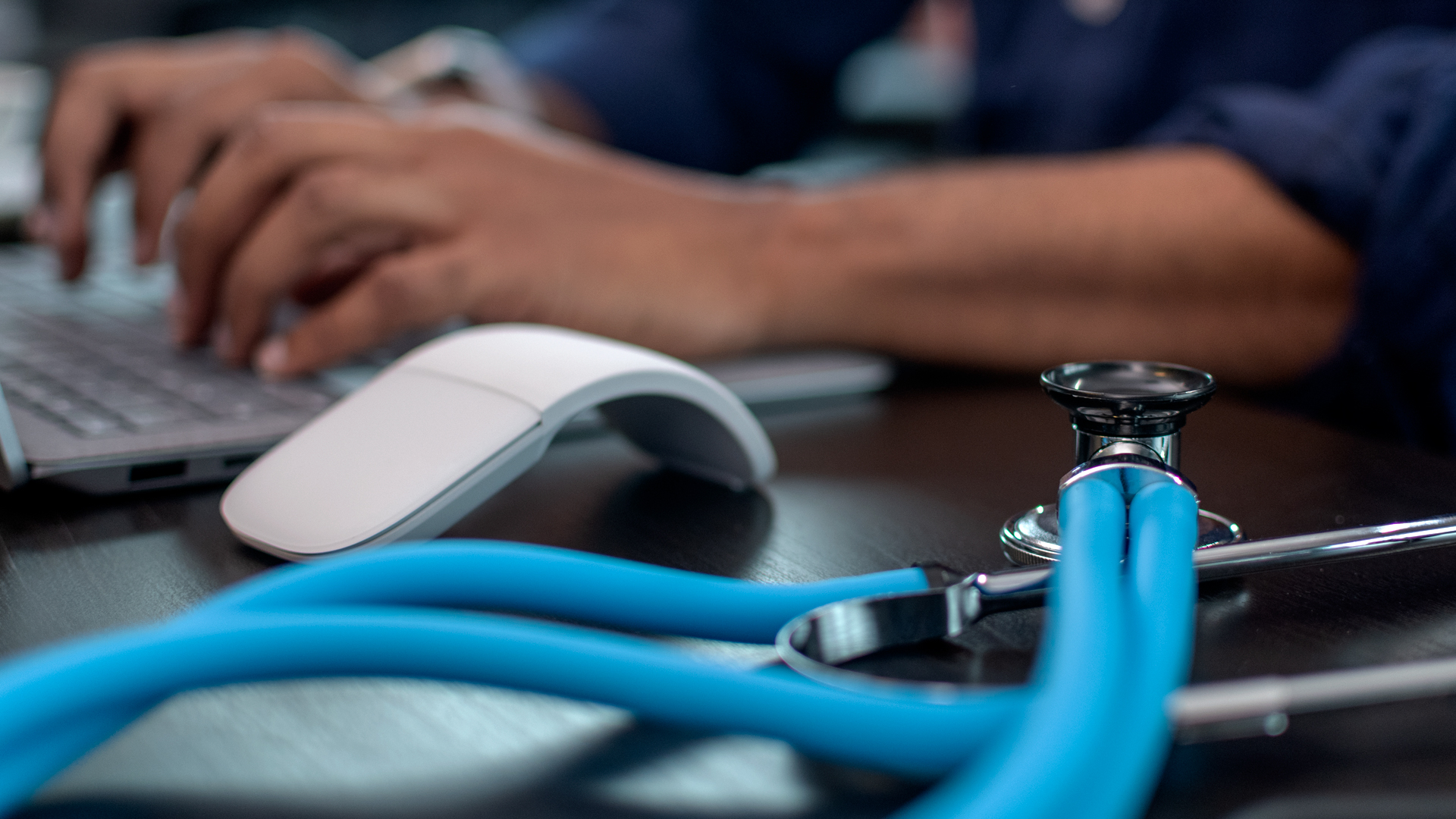 doctor surgeon stethoscope working on laptop