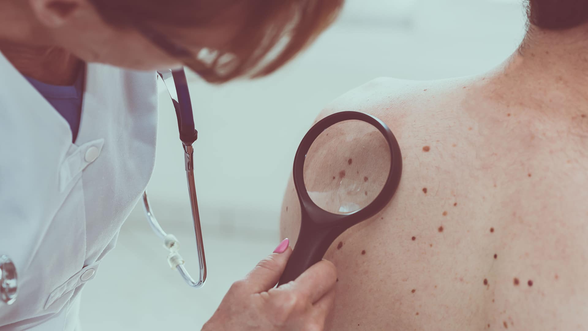 dermatologist checking patient