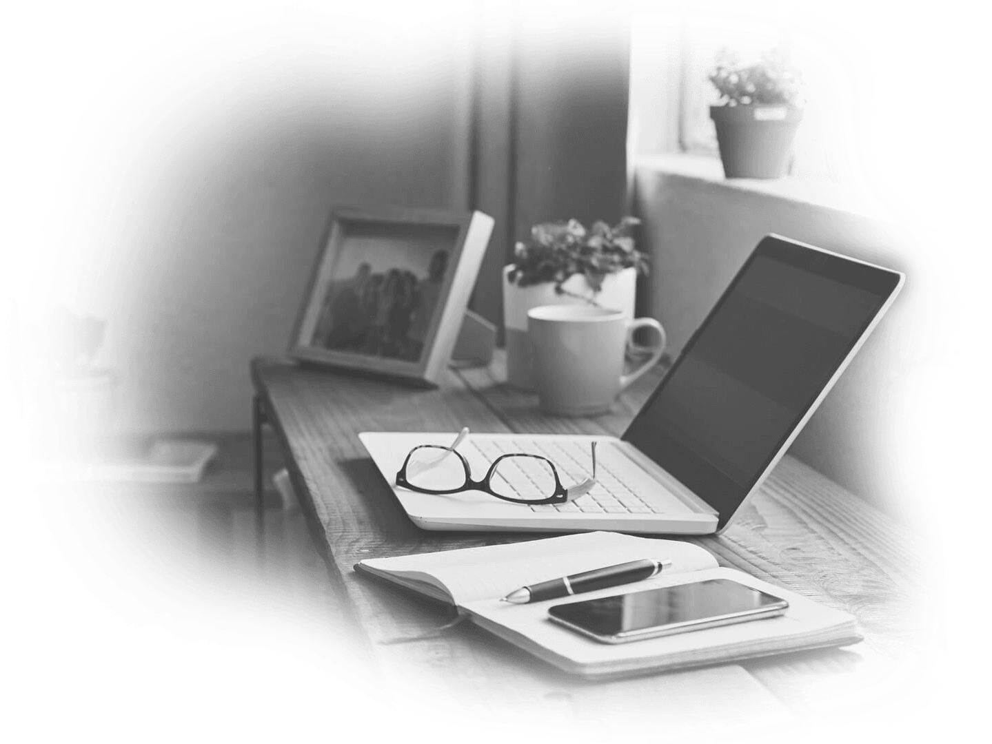 Home office with laptop and smartphone in the desk